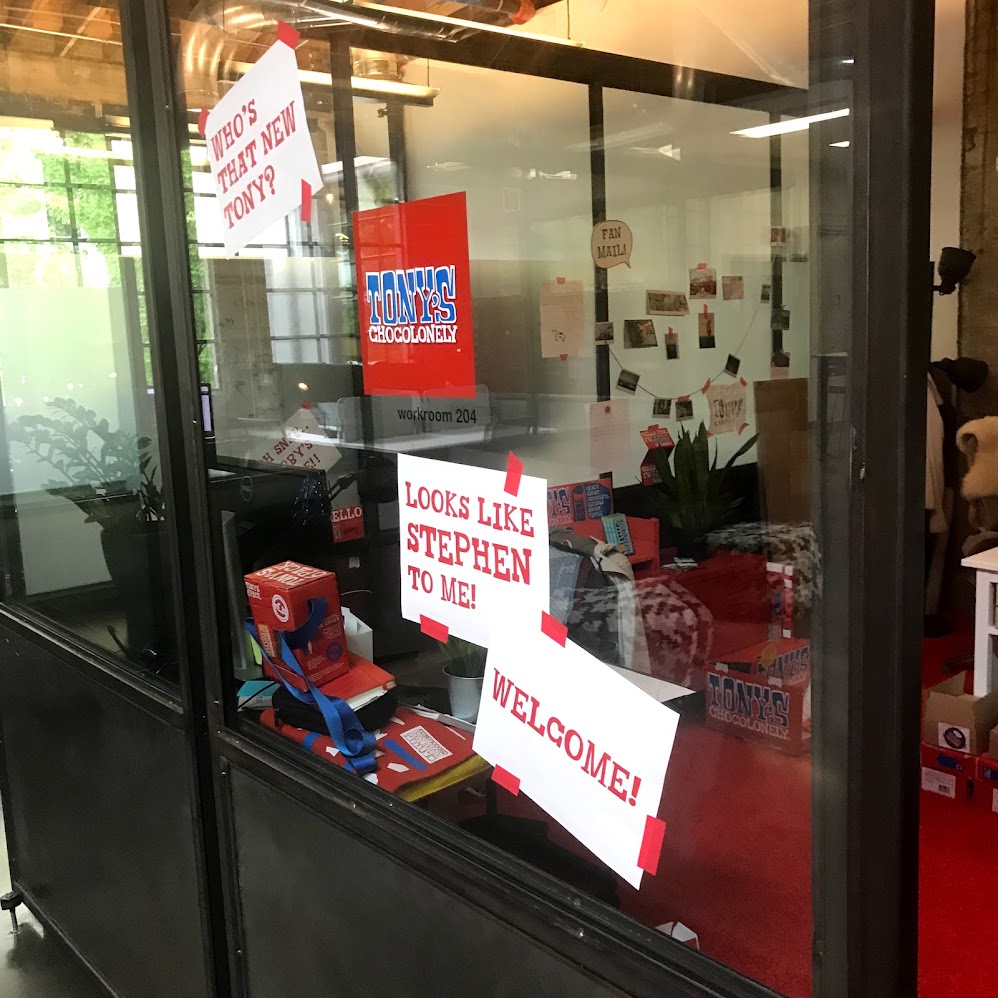 The office window on Stephen’s first day, papered with signs reading “Who’s that new Tony? Looks like Stephen to me! Welcome!”